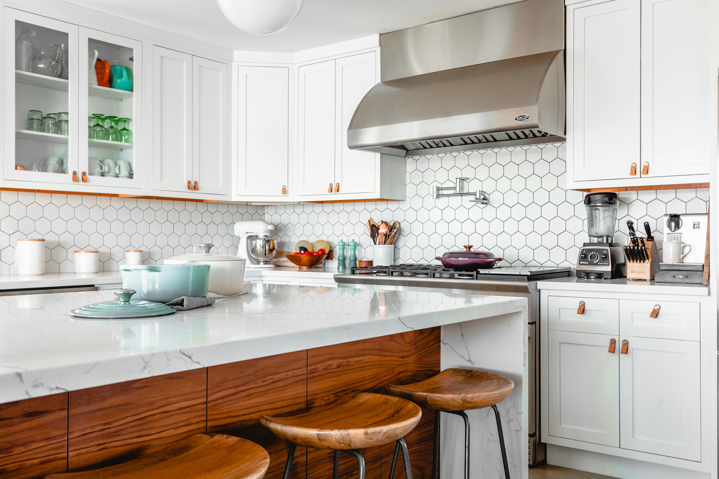 Bright, clean kitchen with a marble island and warm wood accents